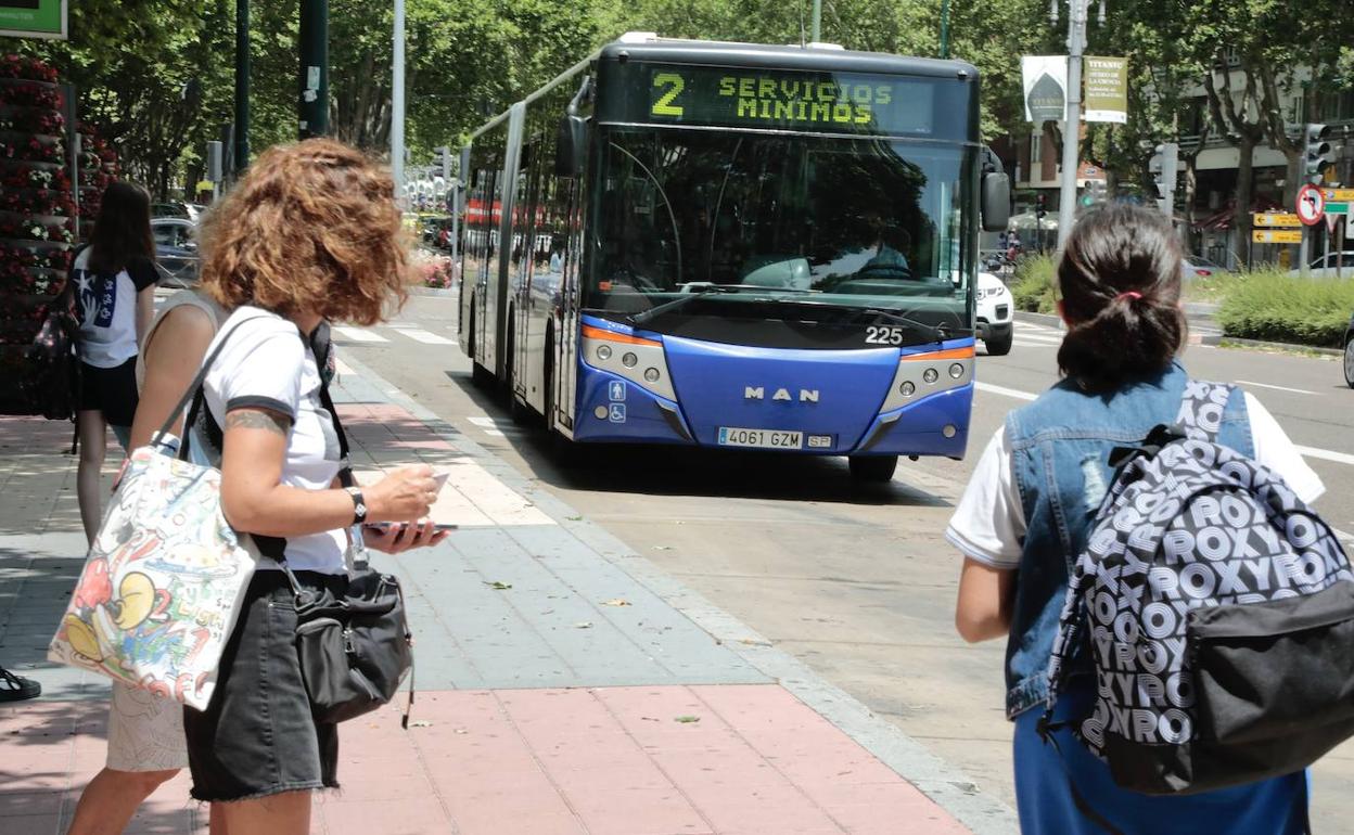 Dos viajeras esperan el autobús de la línea 2.