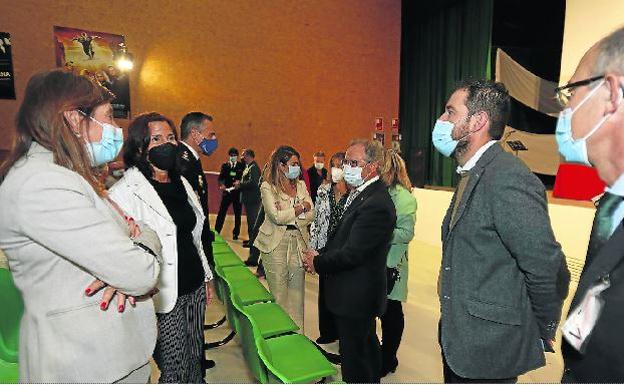 Representantes institucionales, de las fuerzas de seguridad y del propio centro penitenciario conversan en el salón de actos.