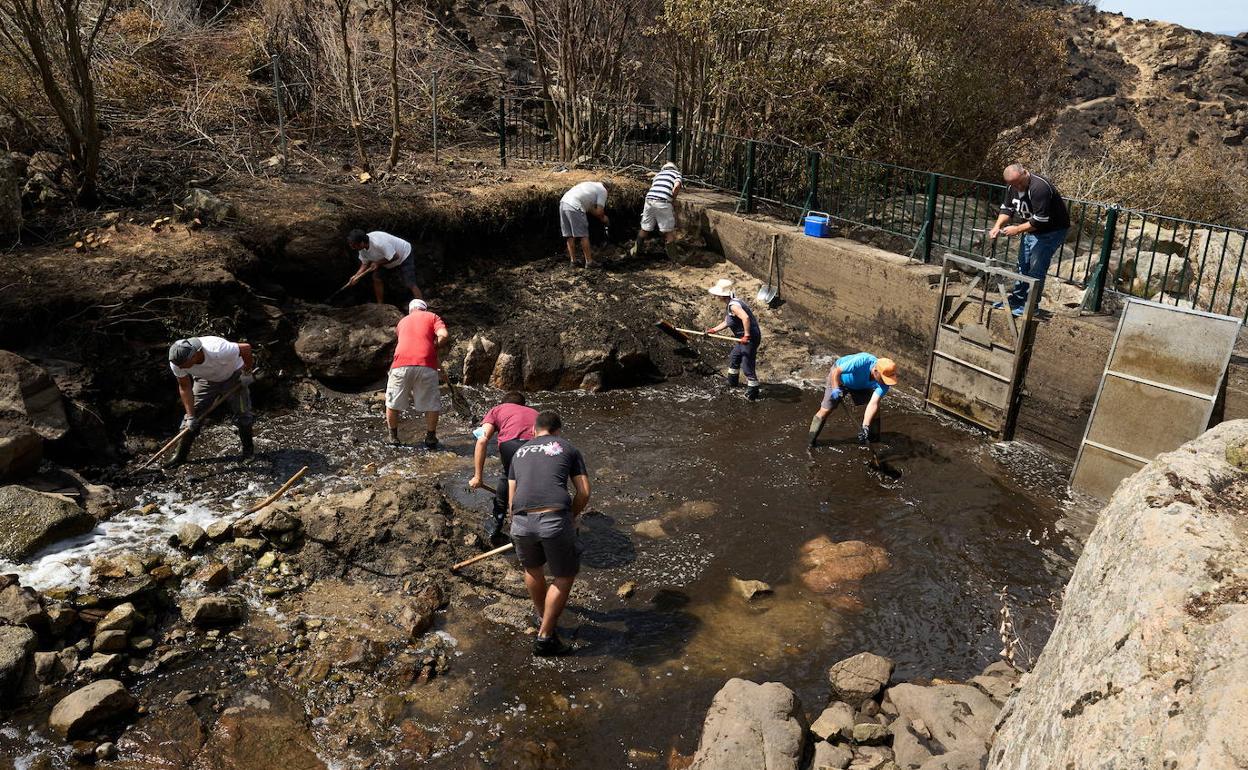 Vecinos de la localidad de Riofrío limpian el punto de captación de agua.