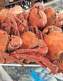 Imagen secundaria 2 - Arriba, La barra del establecimiento, con un segundo comedor al fondo; debajo, a la izquierda, además de los menús y la carta, ha apostado por los mariscos, y a la derecha, gran bandeja de nécoras sobre la vitrina del local.