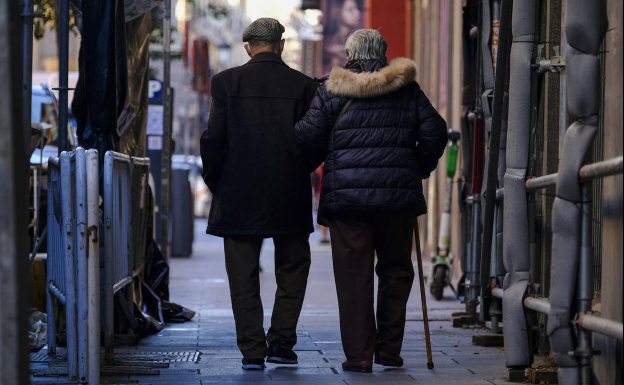 Dos personas caminan por una calle de Madrid, en una imagen de archivo. 