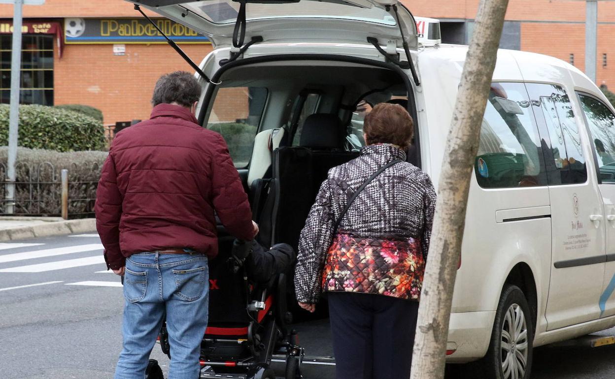 Traslado de una persona mayor en silla de ruedas.