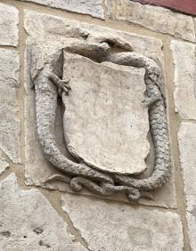 Imagen secundaria 2 - Fachada principal de la Casa de los Miranda. Sobre la puerta, la célebre ventana. Detalle de la torre de la iglesia del Salvador y de uno de los escudos de la portada.