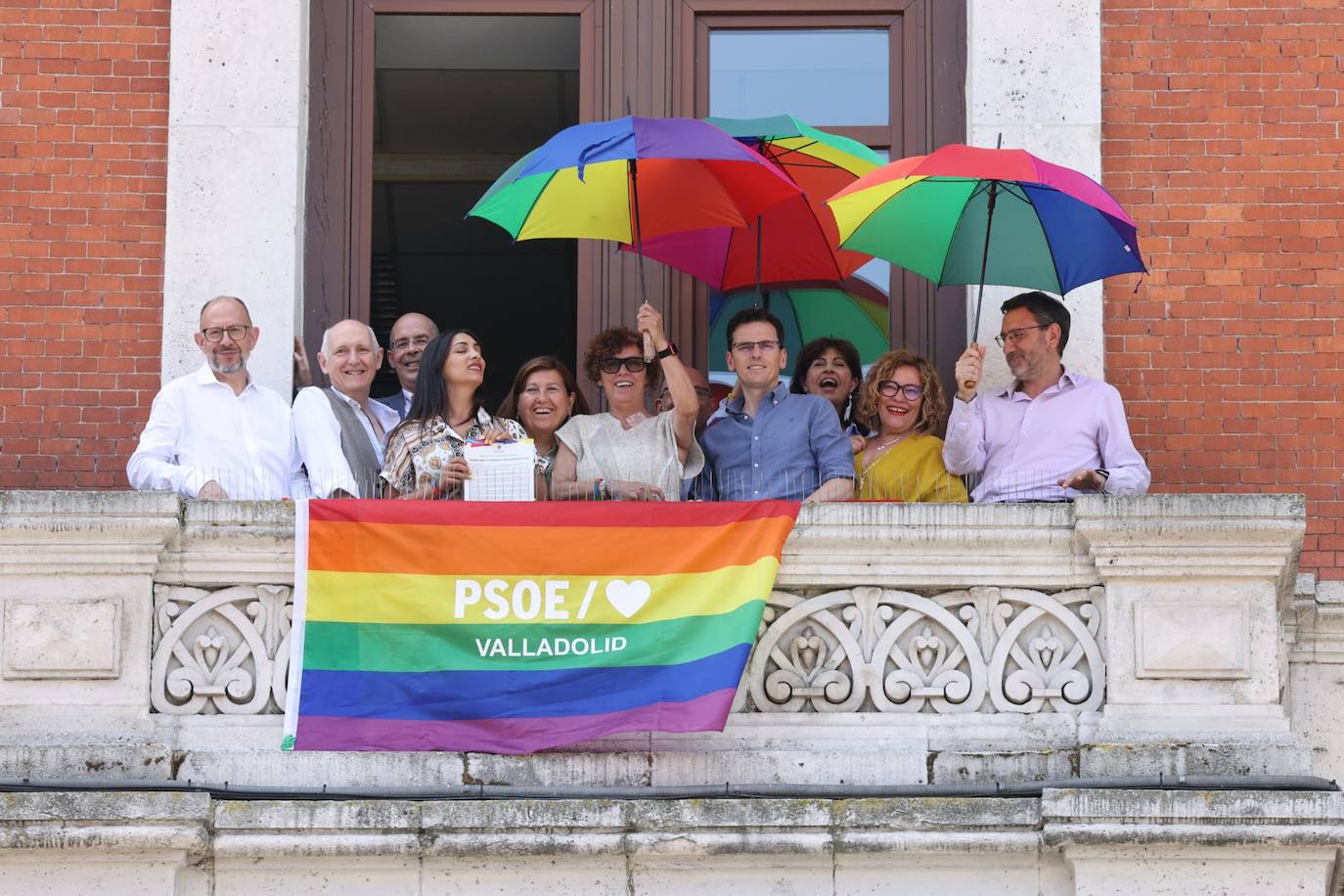 Los concejales del PSOE, conla bandera en la ventana del Grupo Municipal.