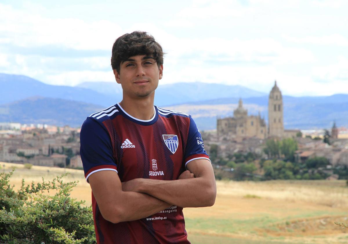 Álex Maroto posa en Zamarramala, su lugar de residencia, con la camiseta de la Gimnástica Segoviana y con la ciudad al fondo.