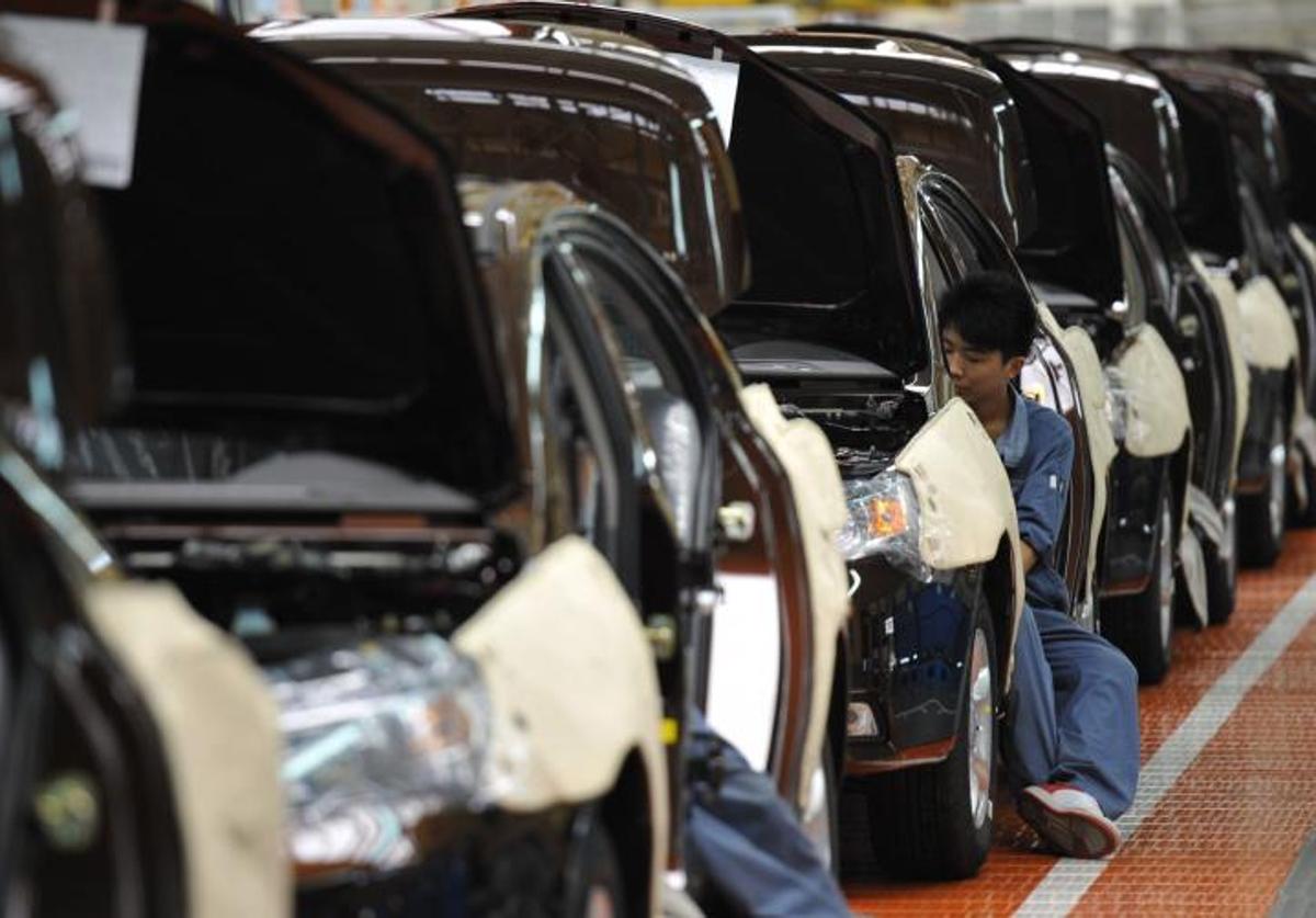 Varios operarios trabajan en una cadena de montaje Geely Motors, en Cixi (China).