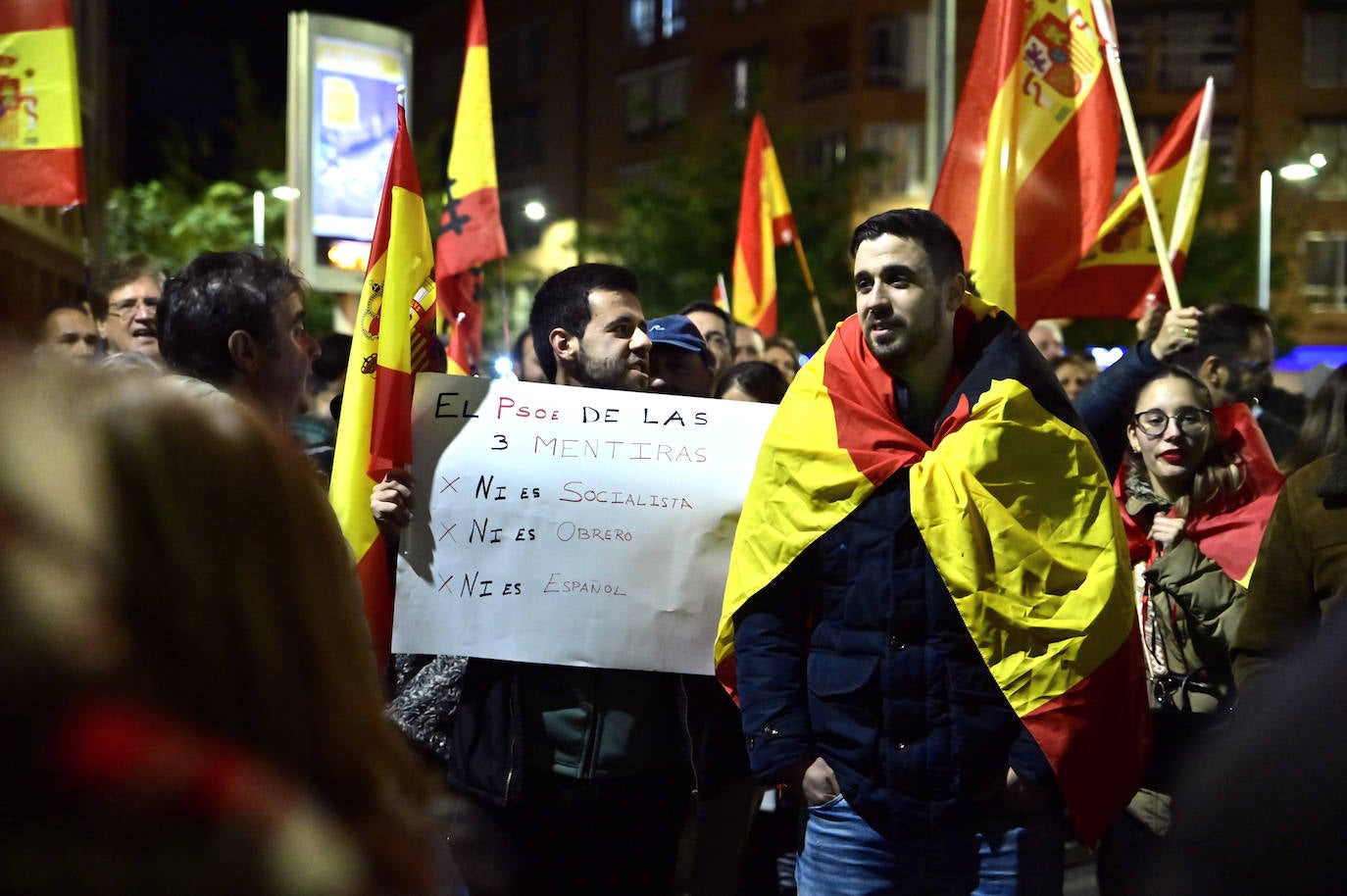 La protesta contra la amnistía frente a la sede del PSOE, en imágenes