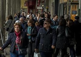 Viandantes en los soportales de la Plaza Mayor de Valladolid.