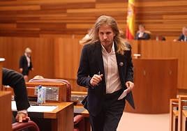 Pablo Fernández, procurador de Podemos, vuelve a su escaño en las Cortes de Castilla y León tras intervenir en un pleno.
