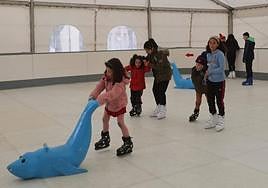 Los niños disfrutan de la pista de hielo al poco se ser inaugurada.