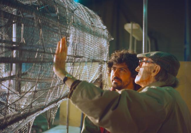 José Luis Medina, en 1999, corrigiendo la jaula de la escultura con Tomás Bañuelos. La estructura es la base del toro de Covaresa.