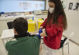 Una enfermera vacuna a un hombre contra la gripe en el centro de salud de San Lorenzo este fin de semana.