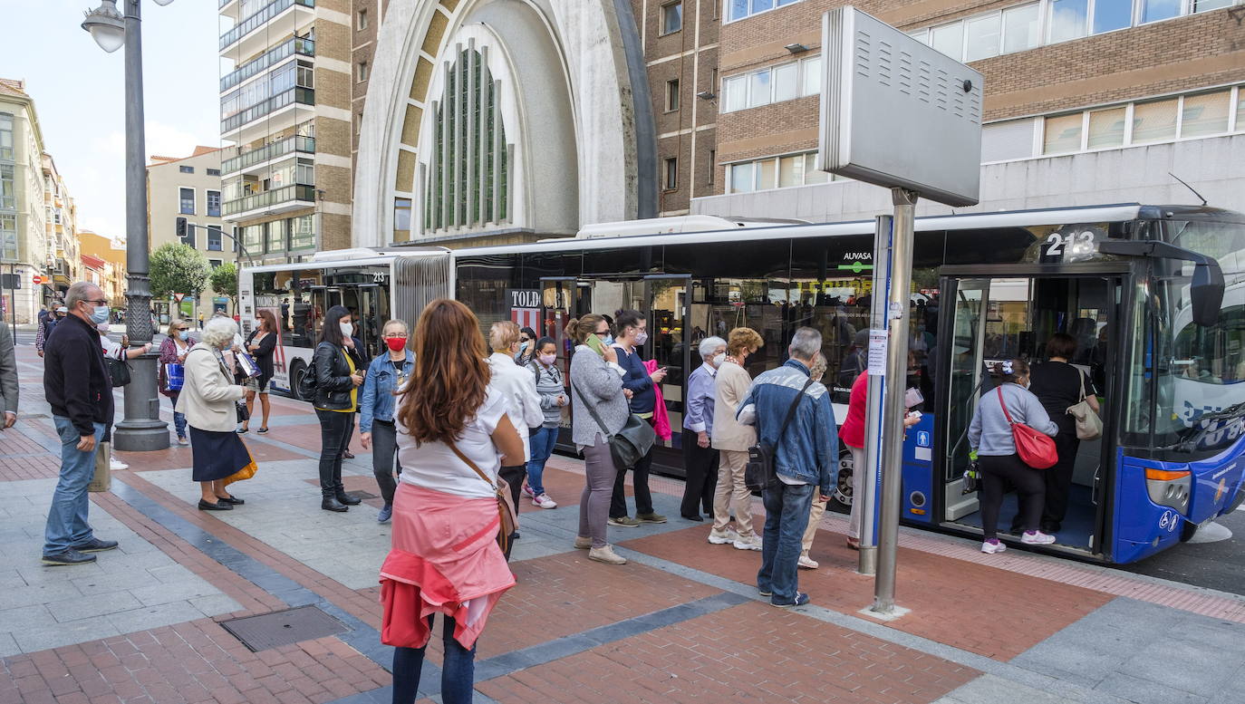 Un grupo de personas espera el autobús en la parada de la plaza de España.