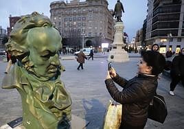 Una mujer fotografía la reproducción del Goya de la plaza de Zorrilla de Valladolid.