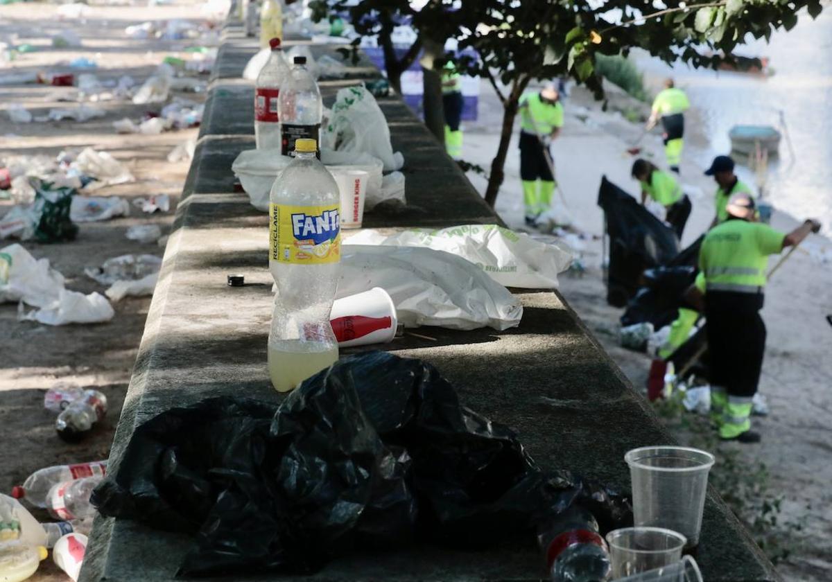 Operarios de la limpieza recogen los restos de la fiesta de San Juan en las Moreras el año pasado.