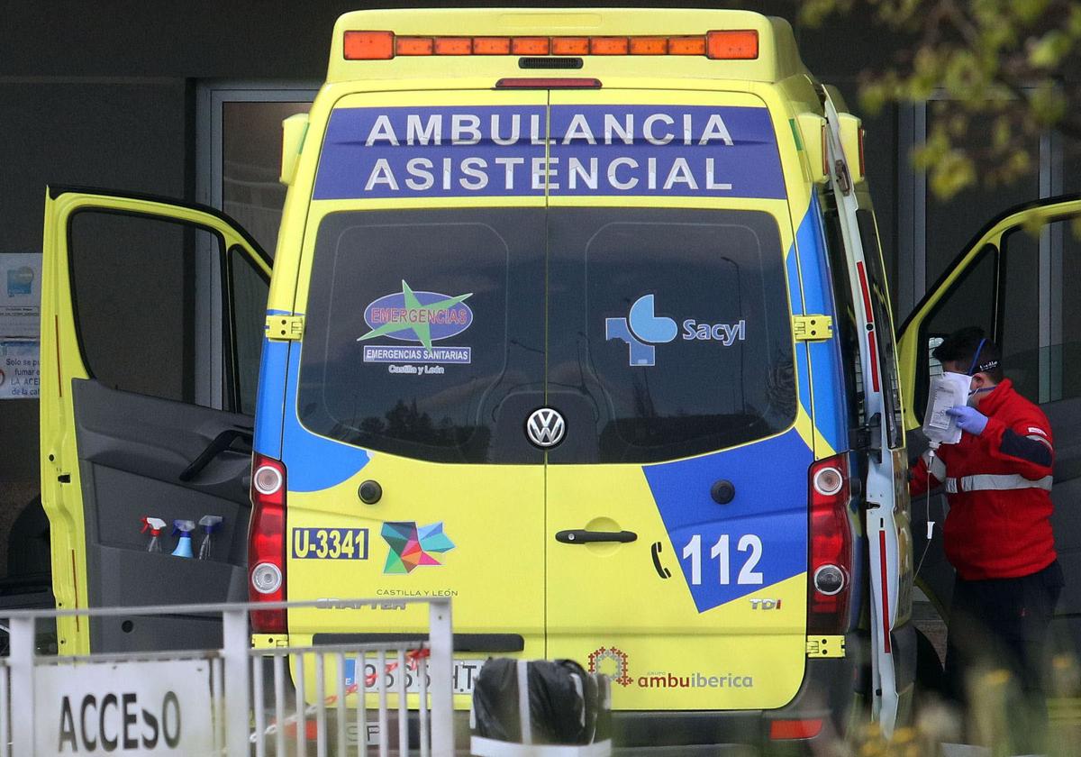 Un profesional sanitario asiste a un paciente en una ambulancia a las puertas de Urgencias.