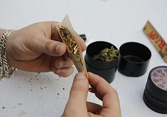 Una persona se lía un porro de cannabis.