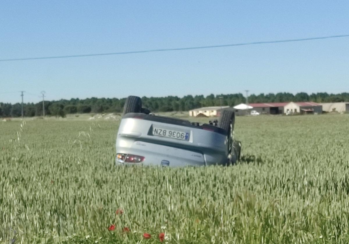 Coche volcado en las tierras de labor.