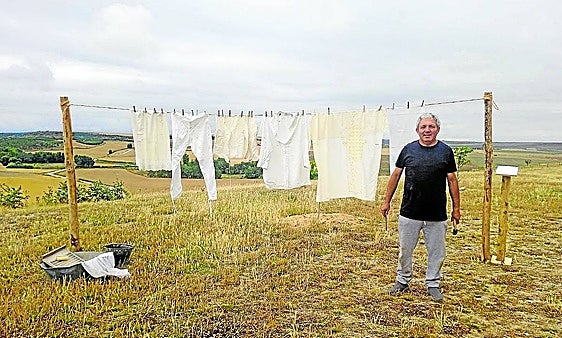 José Alonso junto a la ropa tendida y los objetos para lavar.
