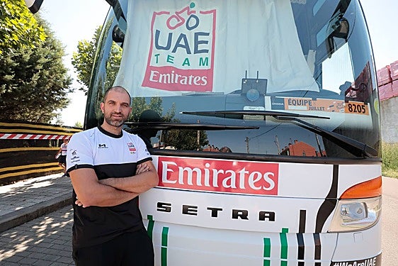 Andrea Bisogno, chófer del UAE Team Emirates, posando frente al autobús del equipo.