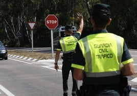 Agente de la Guardia Civil de Tráfico da el alto a un vehículo, en imagen de archivo.