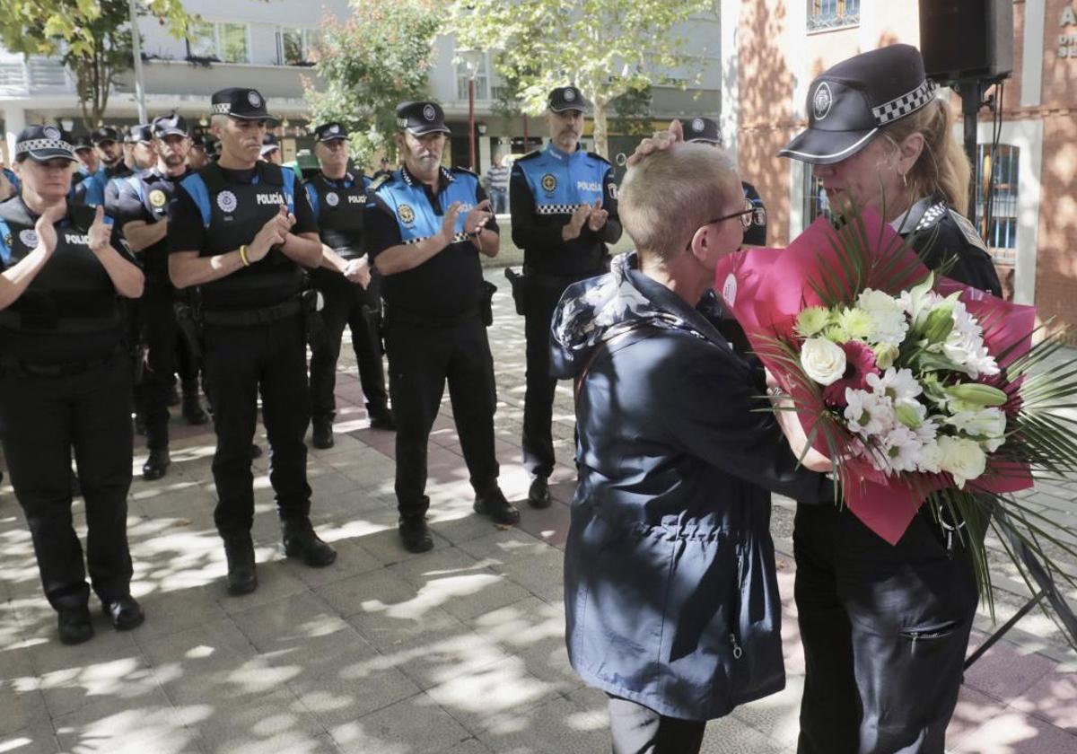 Julia González, superintendente jefa de la Policía Municipal, le entrega un ramos de flores a Dolores, viuda de Daniel Prieto.