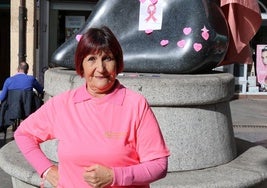 Paula González, delante de la Estatua de la Mujer con una capa rosa.