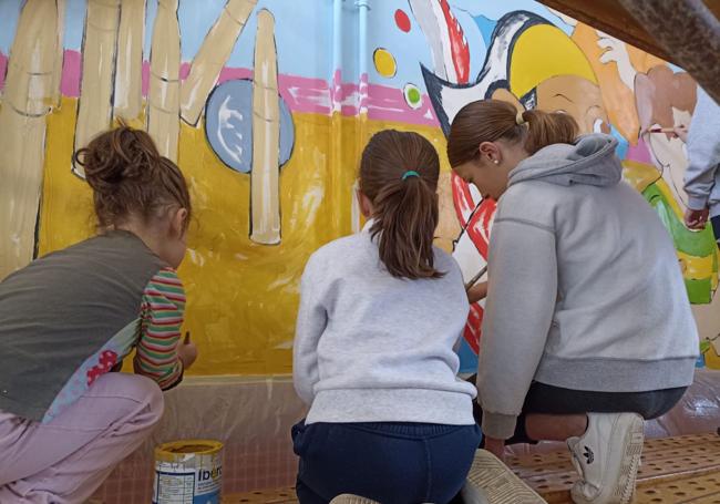 Tres alumnas durante la elaboración de la obra.