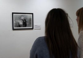 Una visitante observa la fotografía ganadora del concurso Black and White Photo Awards, obra del artista chino Haikun Liang sobre una escena de la fiesta de la primavera en la ciudad de Zhaoqing.