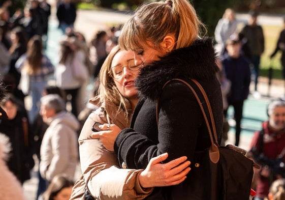 Dos jóvenes se dan un abrazo antes del comienzo del examen MIR, en Valladolid.