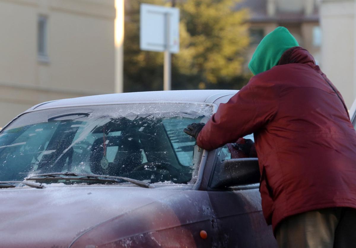 Un hombre retira el hielo de la luna delantera de su coche, en una imagen de archivo.