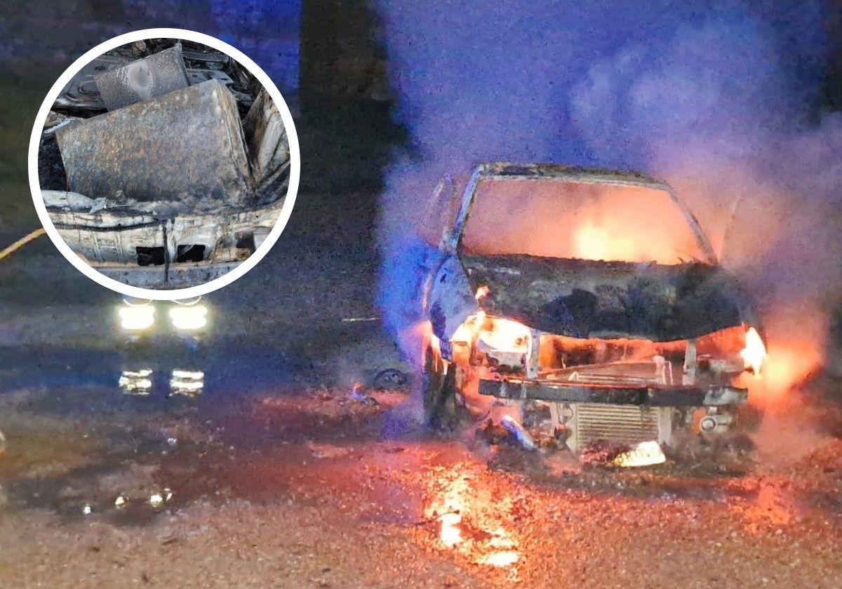 Un bombero de la Diputación sofoca el incendio en un coche en San Miguel del Pino, este miércoles de madrugada. En el círculo, la caja fuerte hallada en el maletero.