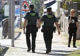 Dos guardias civiles caminan por la travesía de San Rafael.