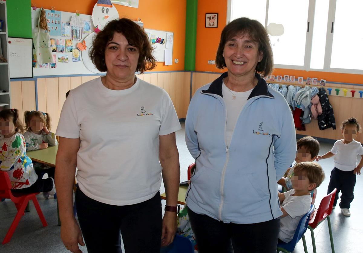 Inmaculada López (izq.) y Ana Hernando, en un aula de la guardería con los niños de fondo.