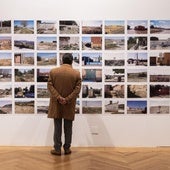 Un hombre observa varias fotografías en la exposición de la sala de La Pasión de Valladolid.