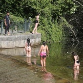 Un grupo de jóvenes se refresca en el Eresma a la altura de la Casa de la Moneda.