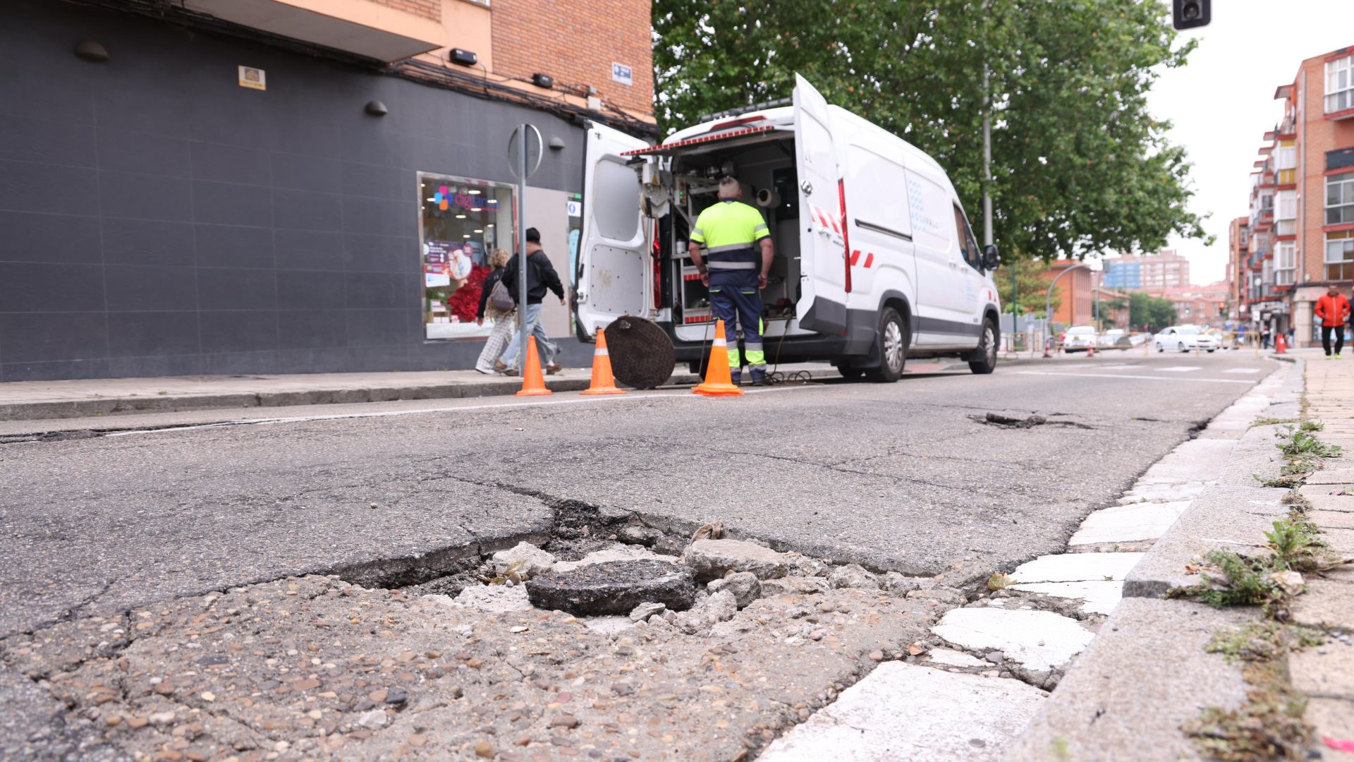 Operarios revisan las alcantarillas de la calle Villabáñez después de que la calzara se abombara y presentara algunas grietas.