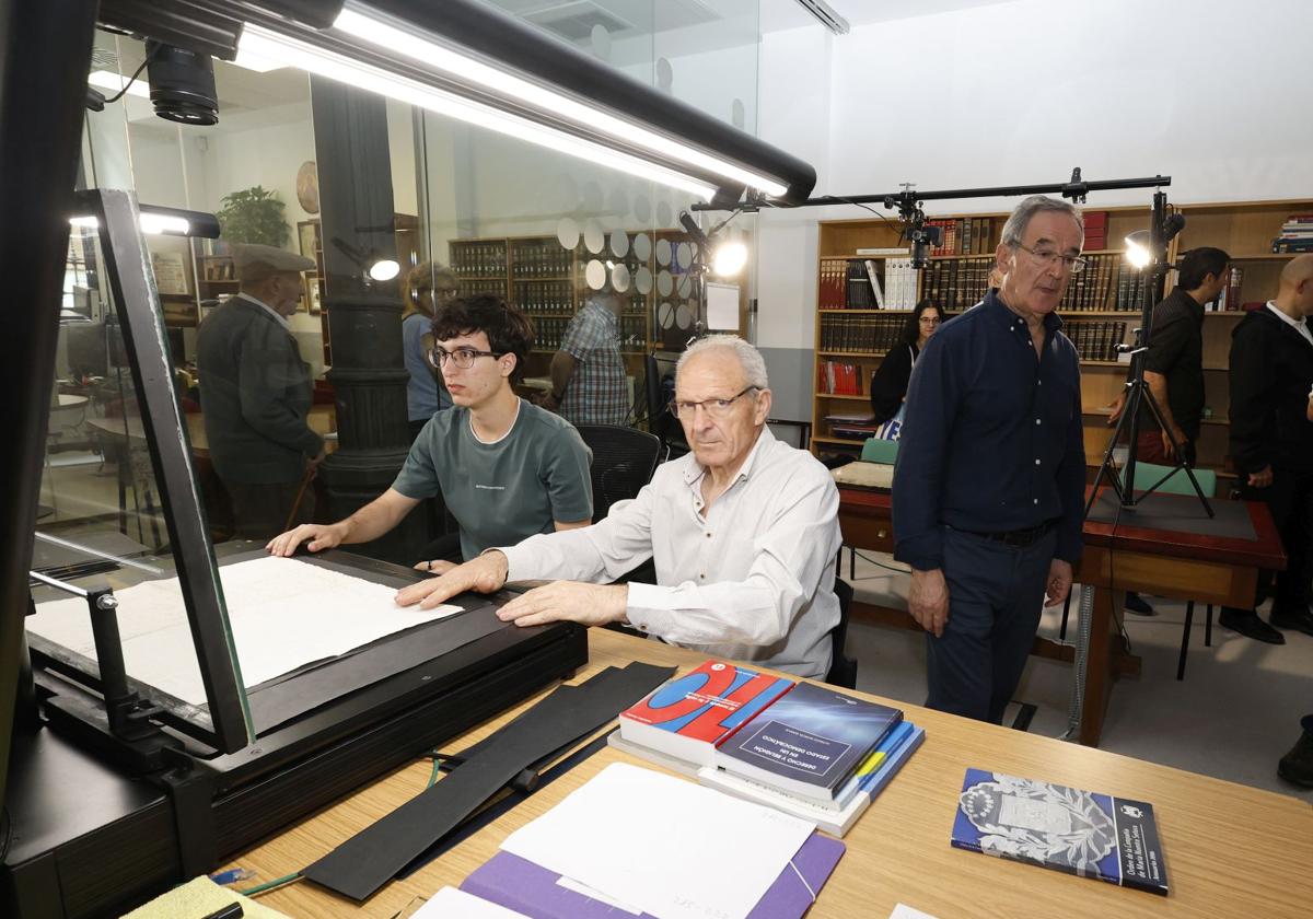 Dionisio Antolín, de pie, guía la visita al Archivo Diocesano, este miércoles , mientras los colaboradores trabajan en las catalogaciones.