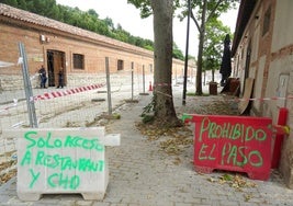 Avisos de la prohibición de pasar por las aceras ya urbanizadas del tramo inicial de la calle Canal salvo a clientes del restaurante o trabajadores de las oficinas de la CHD.