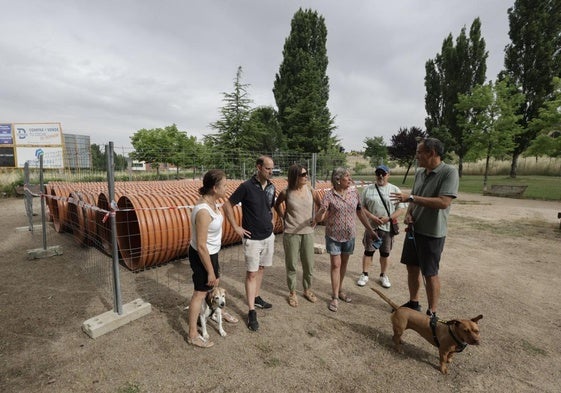 Los impulsores de la iniciativa posan en el parque junto a los tubos para desviar el colector que discurre por el subsuelo.