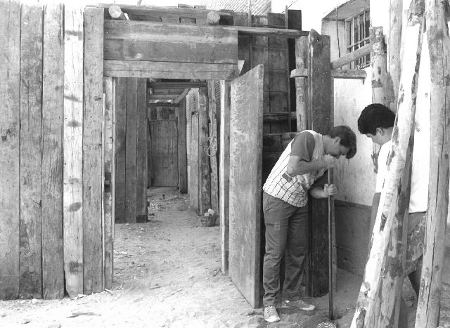 Dos jóvenes montan los toriles en las fiestas de 1995.