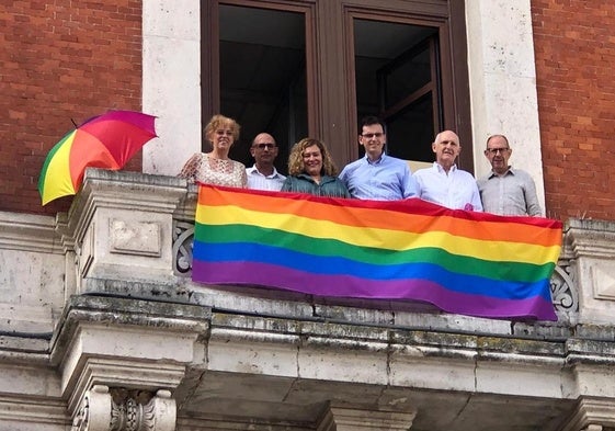Los concejales del PSOE exhiben la bandera LGTBI desde el balcón de su grupo municipal en el Ayuntamiento.