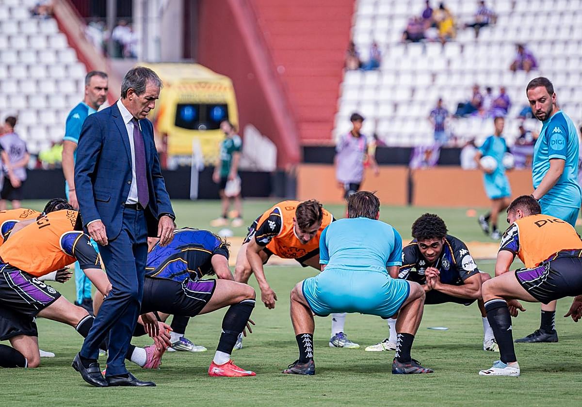 Almada supervisa el calentamiento a pie de césped.