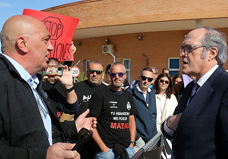 El Defensor del Pueblo, Ángel Gabilondo (derecha), conversa con uno de los manifestantes en la entrada de la cárcel de Segovia.