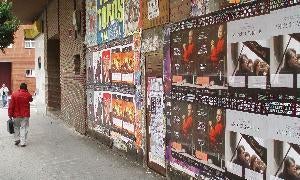 Muro repleto de carteles publicitarios en la calle Estadio. / J. S.
