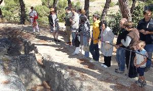 Los asistentes observan una de las tumbas del cementerio./ ANTONIO DE TORRE