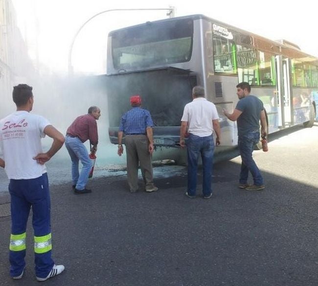 Varias personas inspeccionan el motor, tras arder. 