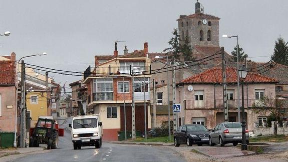 Vista de una calle de Aldea Real, con la torre de la iglesia parroquial al fondo. 