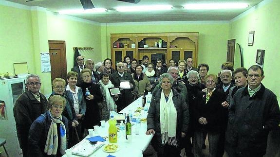 Los miembros de la asociación de mayores posan junto a los homenajeados . 