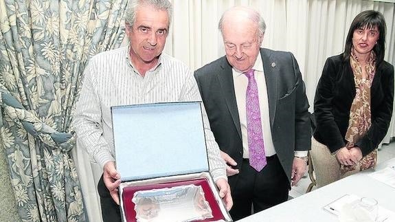 Luis Vicente de la Torre, con la placa que recibió ayer por sus 22 años en Aecopa, junto al presidente y la secretaria general, Carmen Casado. 